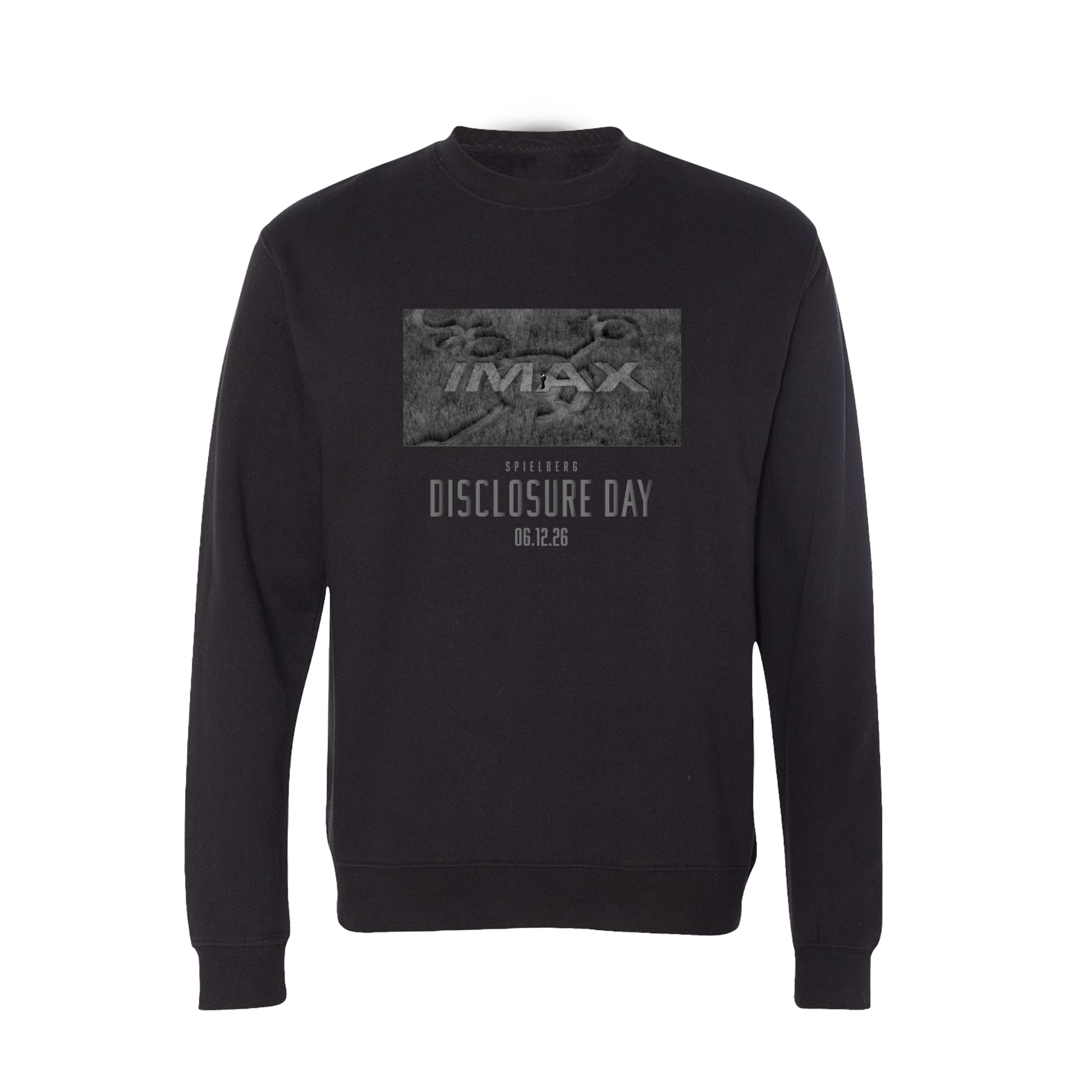 Promotional graphic for the “Disclosure Day x IMAX” exclusive crewneck sweatshirt. The image features a black crewneck with a tonal gray graphic and “Disclosure Day 06.12.26” text on the front, displayed against a light gray textured background.