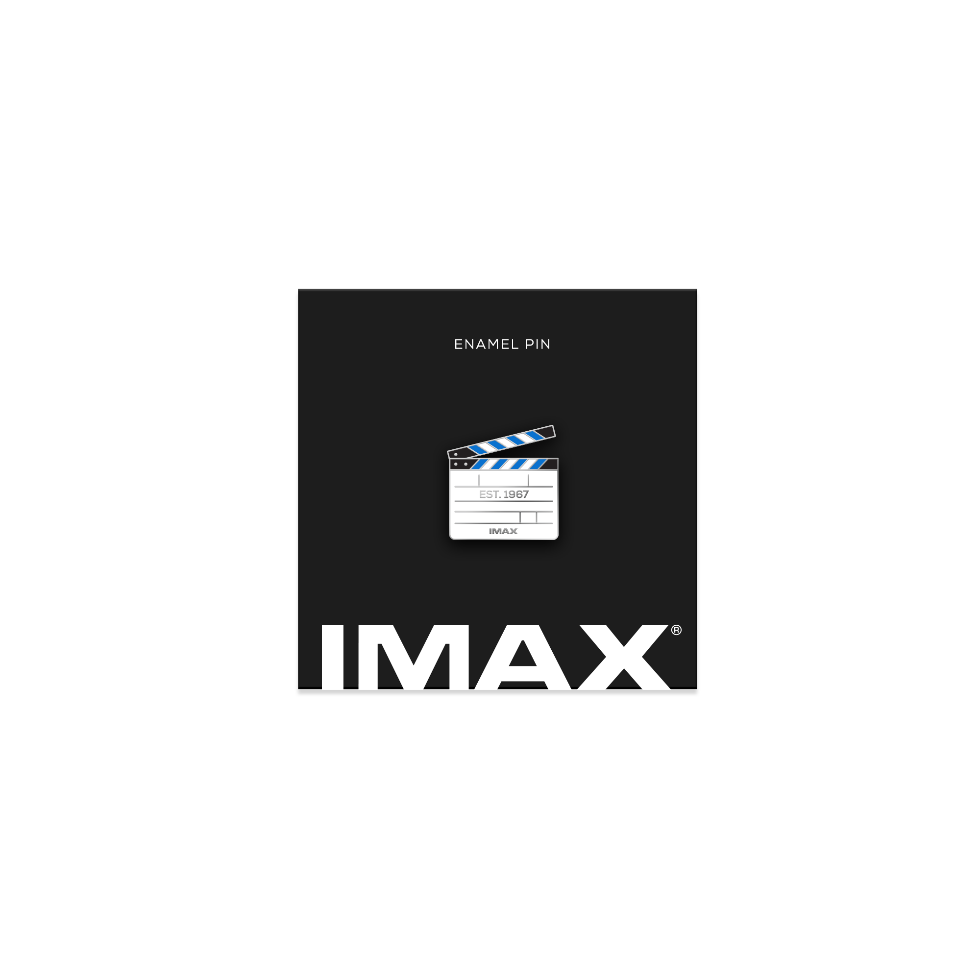A silver pin in the shape of a camera clapper board with the IMAX logo and est. 1967 on it on a black, IMAX-branded backing card