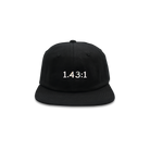 A black hat that has 1.43:1 printed in white on the front. 