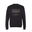 Promotional graphic for the “Disclosure Day x IMAX” exclusive crewneck sweatshirt. The image features a black crewneck with a tonal gray graphic and “Disclosure Day 06.12.26” text on the front, displayed against a light gray textured background. 