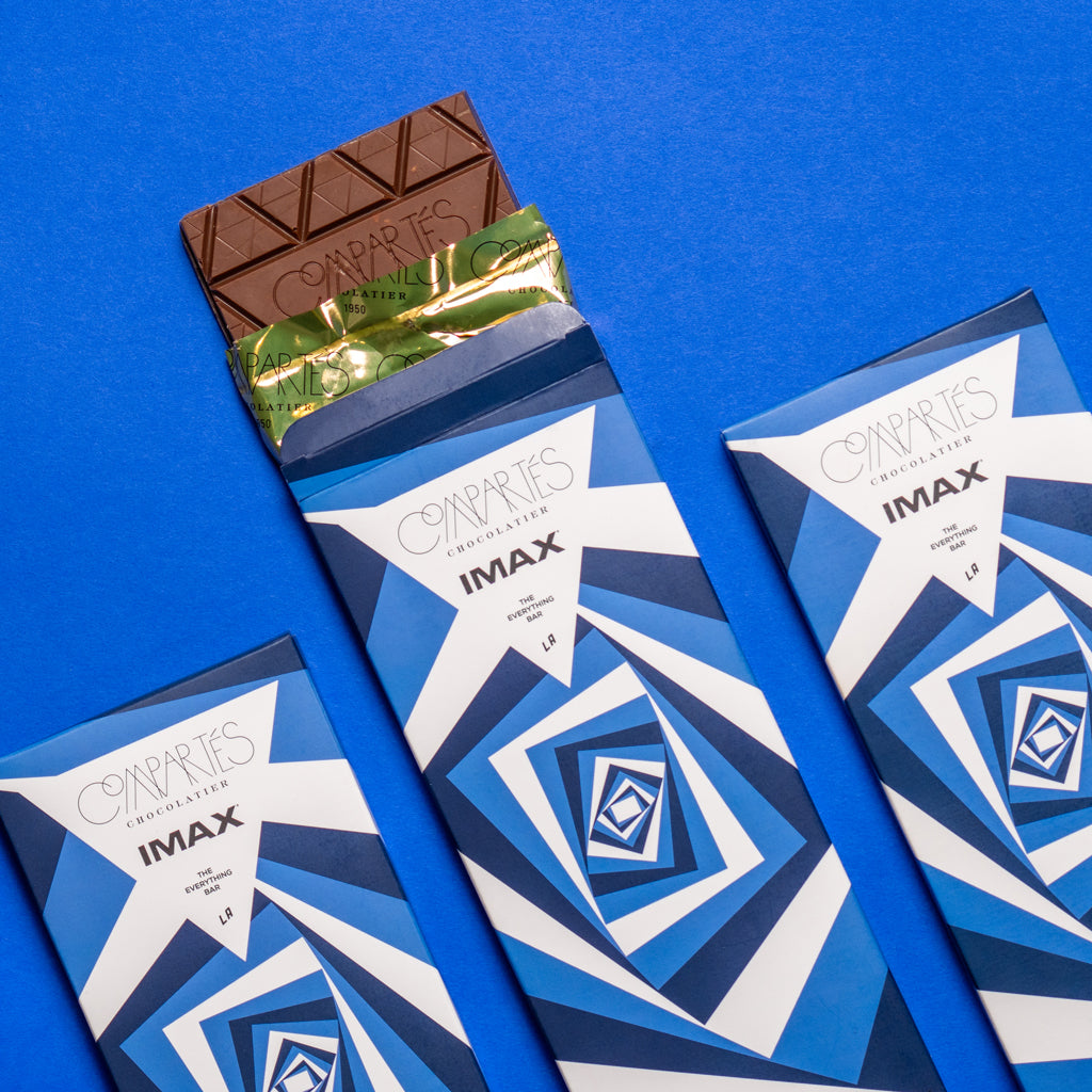 Three IMAX and Compartés chocolate bars. 