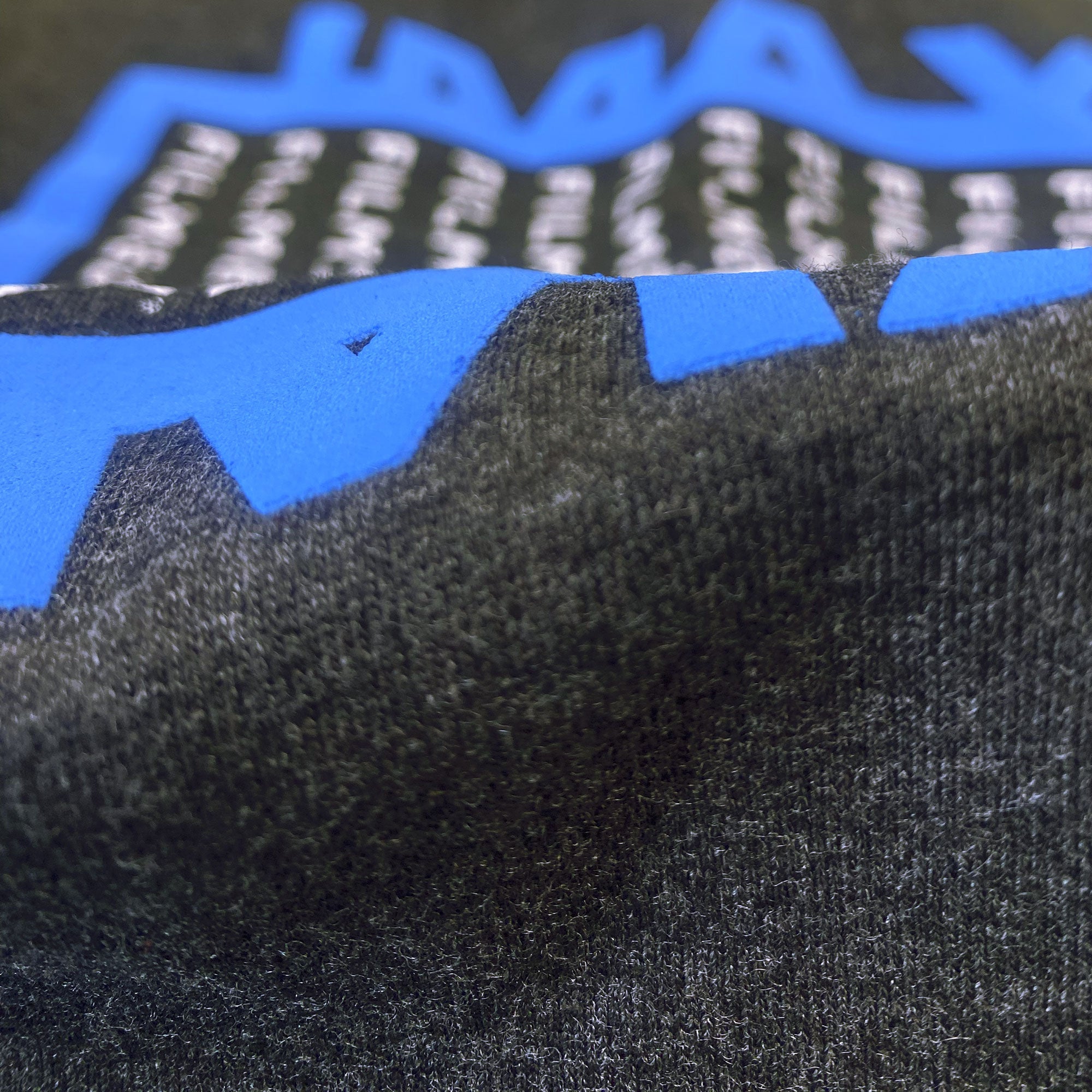 A close up on the high-density blue ink on the crewneck sweatshirt.  