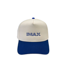 Cream and royal blue cotton dad hat featuring embroidered IMAX outline logo on the front, curved blue brim, and adjustable back strap and embroidered “’67” detail on the side.