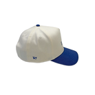 Cream and royal blue cotton dad hat featuring embroidered IMAX outline logo on the front, curved blue brim, and adjustable back strap and embroidered “’67” detail on the side.