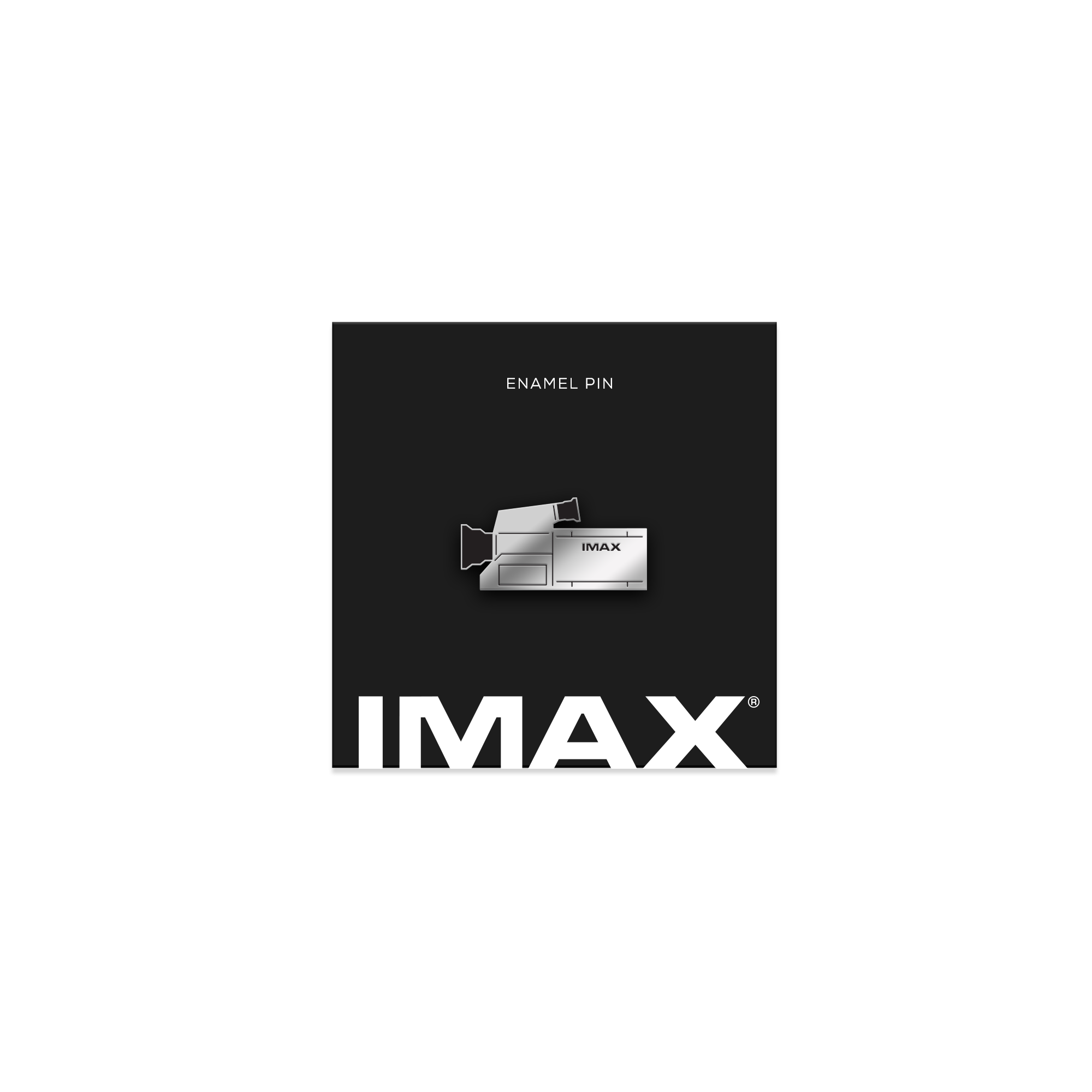 A silver pin in the shape of an IMAX film camera on a black, IMAX-branded backing card.