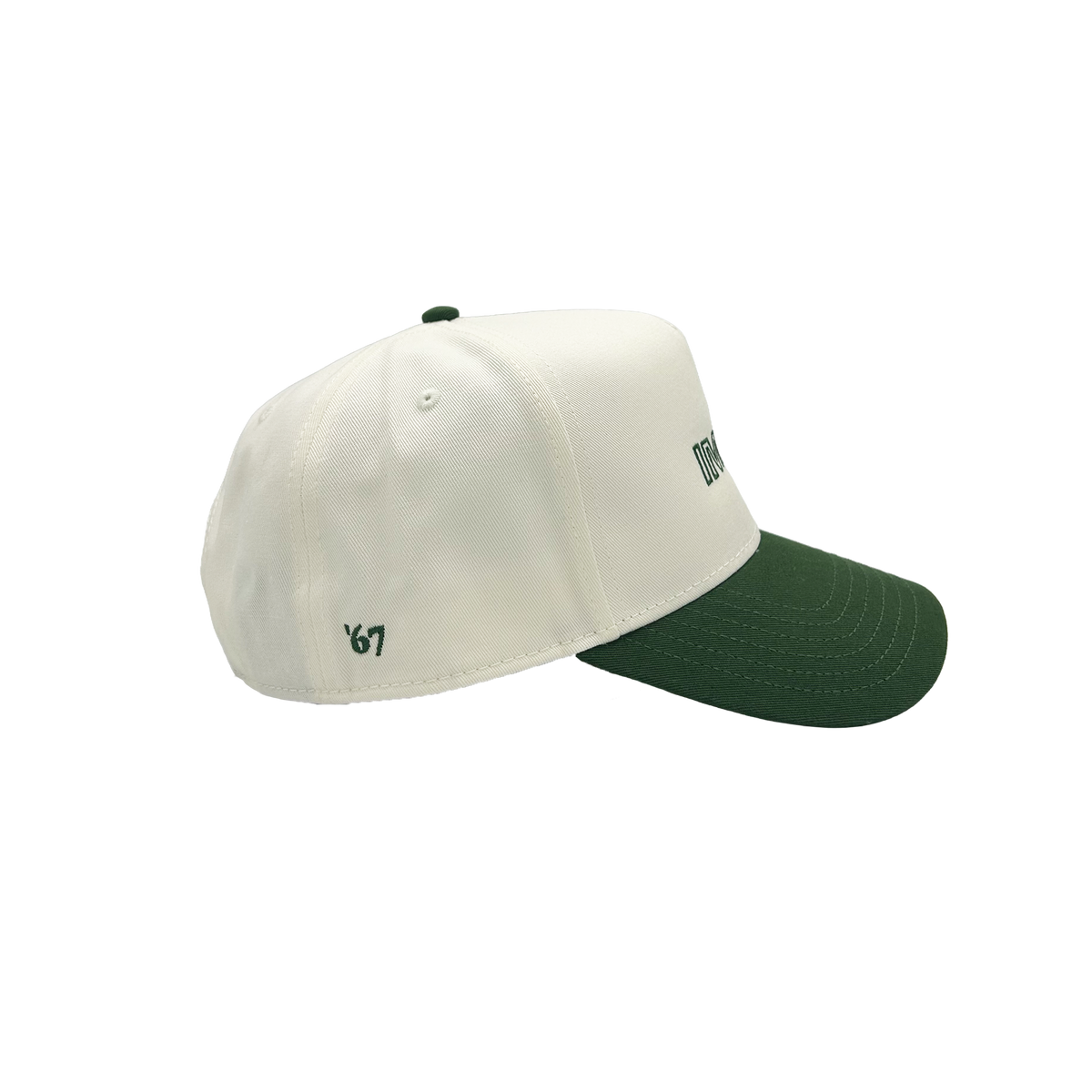 A structured baseball cap with an off-white crown and a dark forest green curved brim, featuring small embroidered green text on the side.