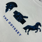Embroidered design on a white fabric with blue patterns including a helmet, shield, and horse, with 'The Odyssey' text.