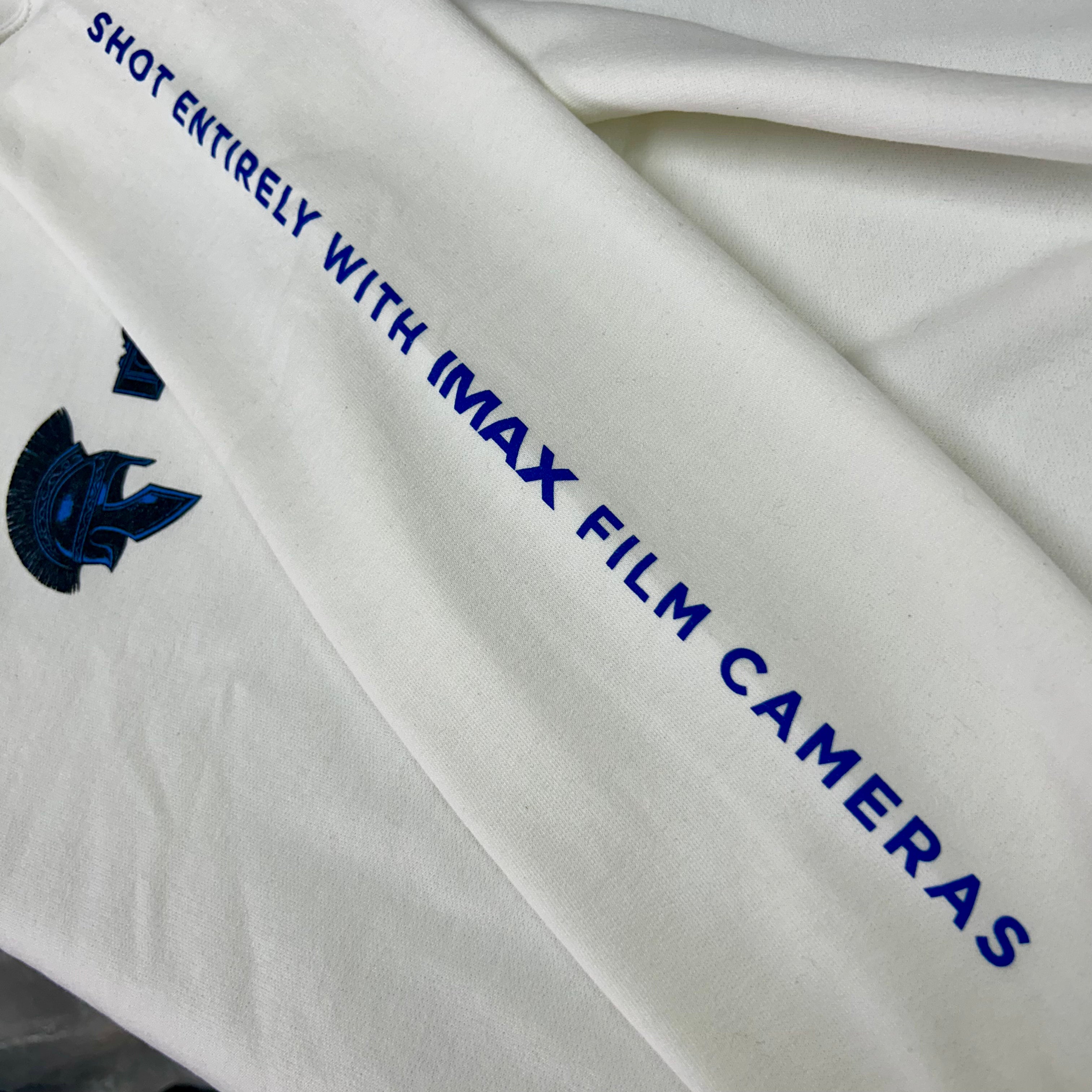 White fabric with blue text and logo, featuring 'IMAX' branding.