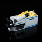 IMAX popcorn machine with popcorn on a black background