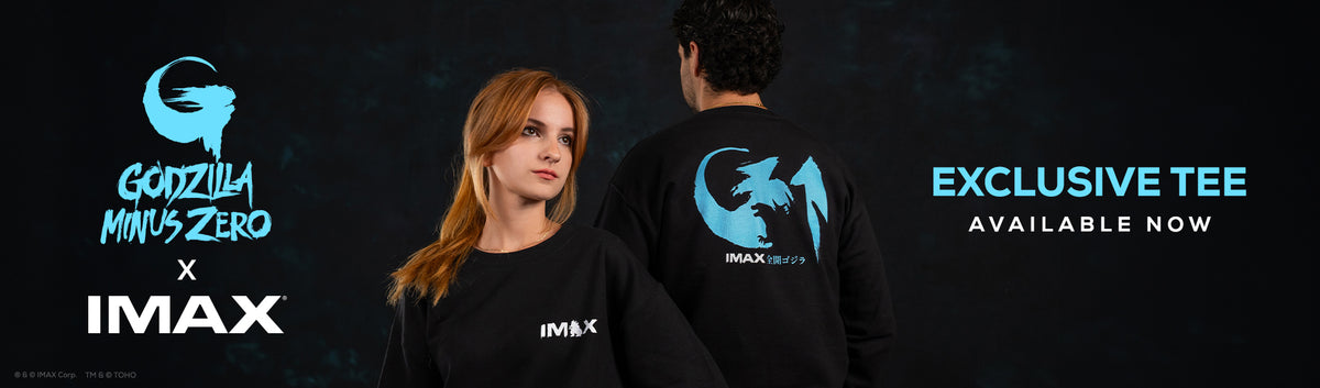 Promotional banner for an exclusive IMAX x Godzilla Minus Zero t-shirt collaboration. It features a woman wearing a black crewneck t-shirt with a white IMAX logo on the front, and a man wearing a black t-shirt from the back, which displays a large blue Godzilla Minus Zero logo and IMAX branding.