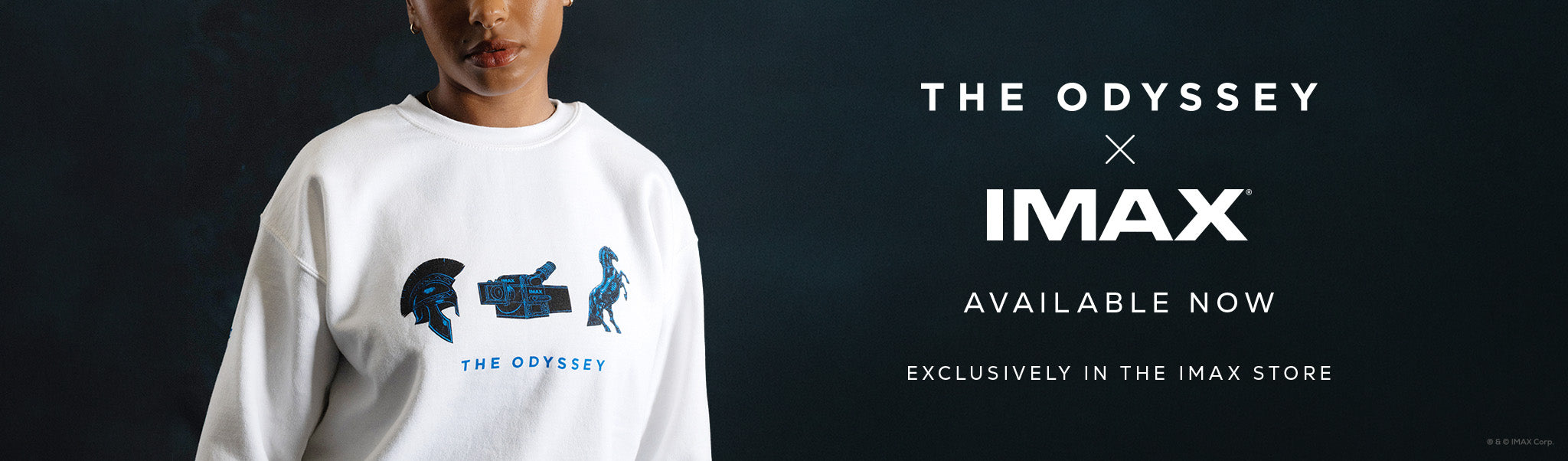 Person wearing a white sweatshirt with 'The Odyssey' graphic, featuring IMAX branding.