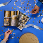 Hands of two people building a puzzle.
